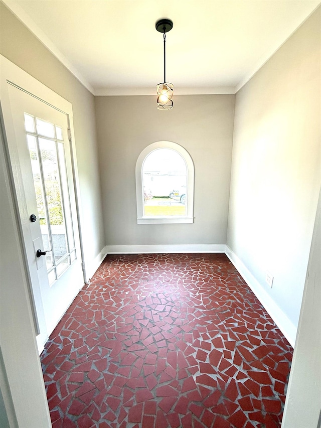 - empty room featuring baseboards, ornamental molding, and a wealth of natural light