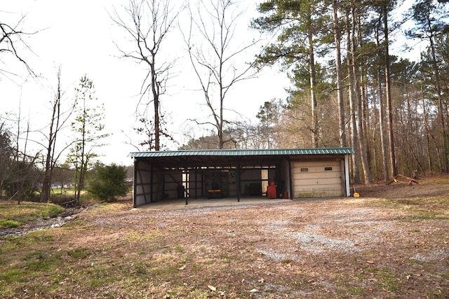 garage featuring driveway and a carport