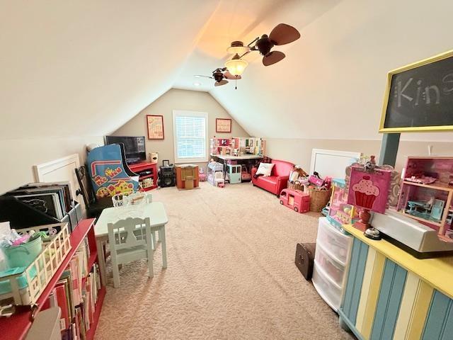 playroom featuring carpet flooring, ceiling fan, and lofted ceiling