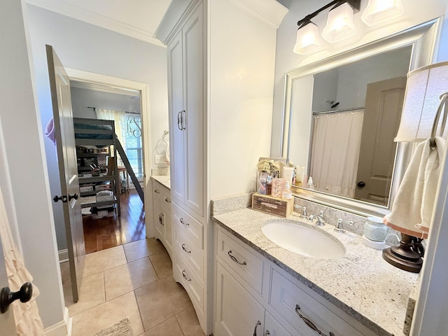 bathroom featuring tile patterned flooring, vanity, and ornamental molding