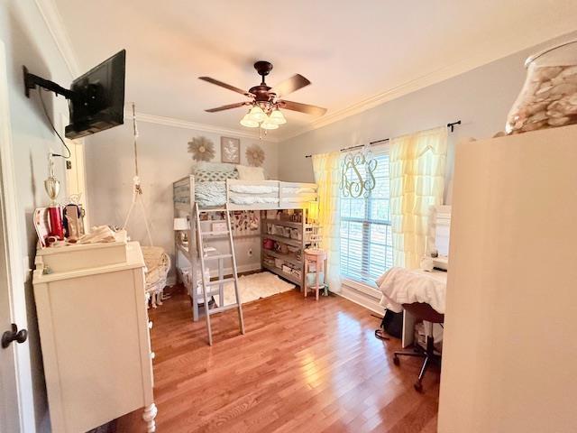 bedroom featuring hardwood / wood-style floors and ornamental molding