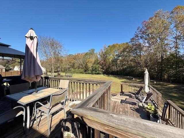 deck with a gazebo and a lawn