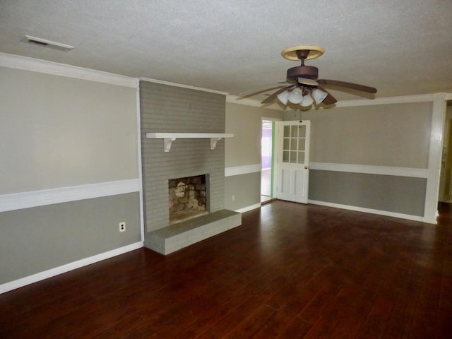 unfurnished living room featuring ornamental molding, a brick fireplace, a textured ceiling, and wood finished floors