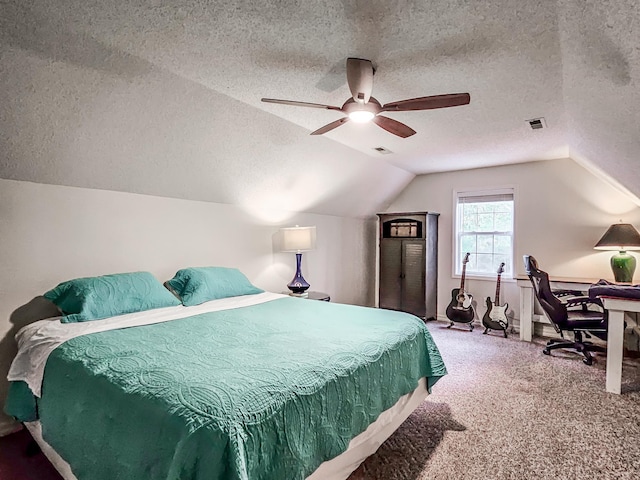 carpeted bedroom featuring a textured ceiling, vaulted ceiling, and ceiling fan