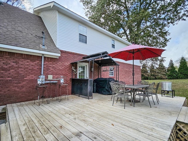 wooden terrace with a grill