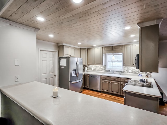 kitchen featuring appliances with stainless steel finishes, tasteful backsplash, wooden ceiling, and sink