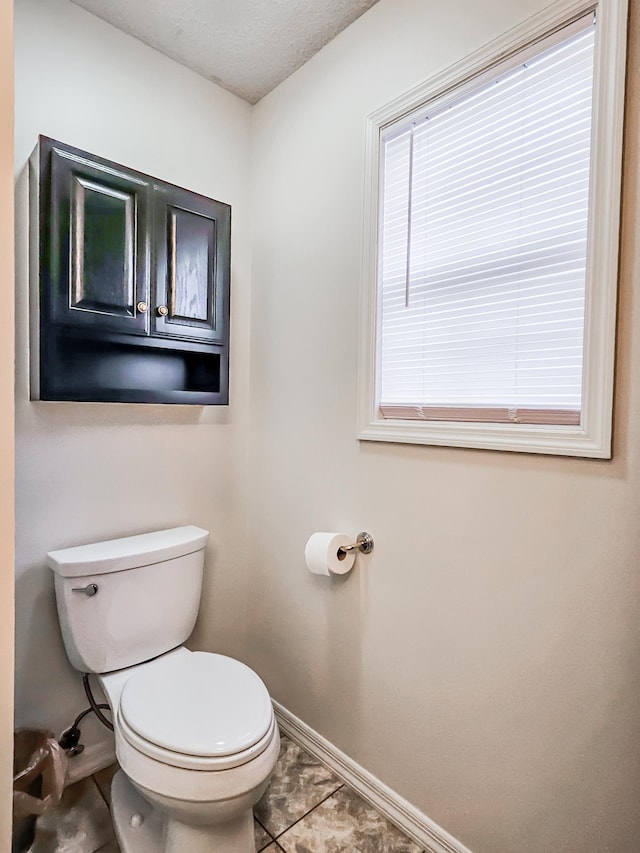 bathroom with tile patterned floors and toilet