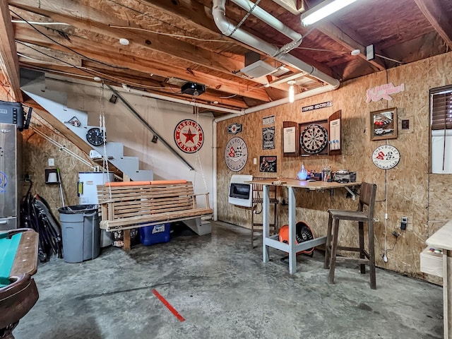 misc room with concrete flooring and a workshop area