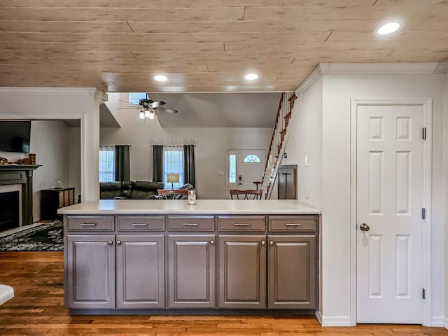 kitchen with ceiling fan, dark hardwood / wood-style flooring, and wood ceiling