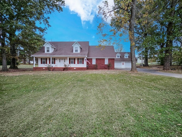 cape cod home featuring a porch, a garage, and a front lawn