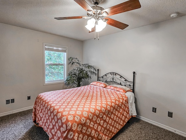 carpeted bedroom with a textured ceiling and ceiling fan