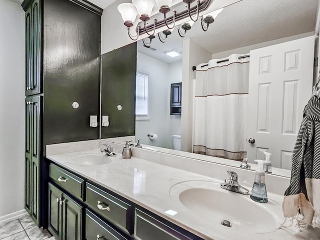 bathroom featuring vanity, toilet, and a textured ceiling