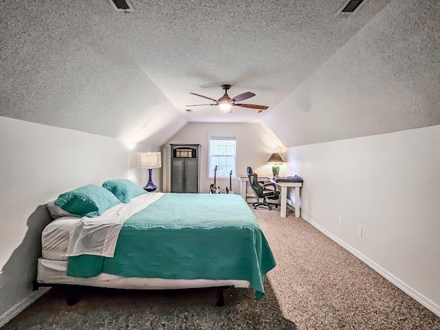 carpeted bedroom with lofted ceiling, ceiling fan, and a textured ceiling