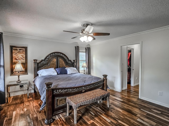 bedroom featuring ceiling fan, crown molding, dark hardwood / wood-style floors, and a textured ceiling