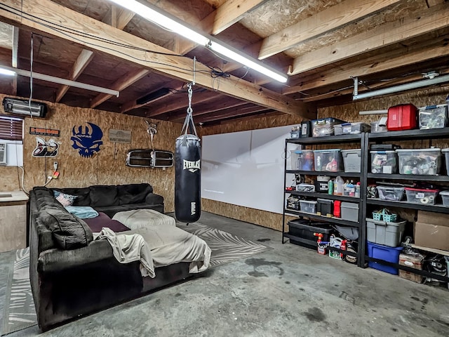 basement featuring wood walls