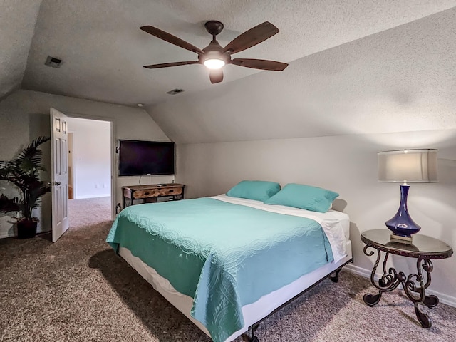 carpeted bedroom featuring a textured ceiling, ceiling fan, and vaulted ceiling