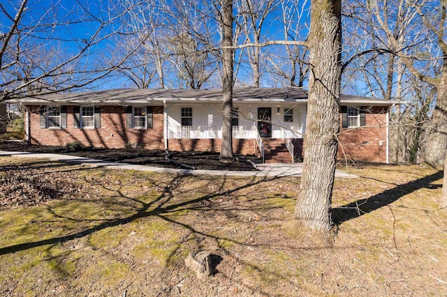 ranch-style home featuring crawl space, a front lawn, a porch, and brick siding