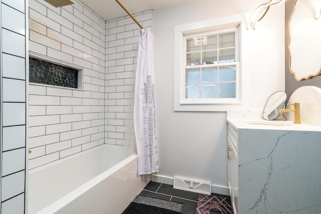 bathroom featuring shower / tub combo with curtain, visible vents, vanity, baseboards, and tile patterned floors