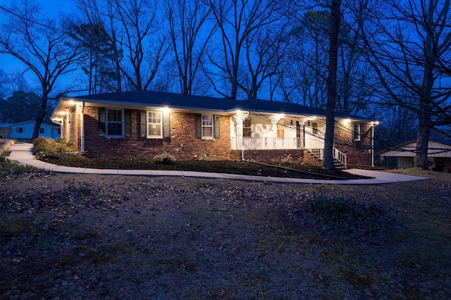 ranch-style house featuring brick siding