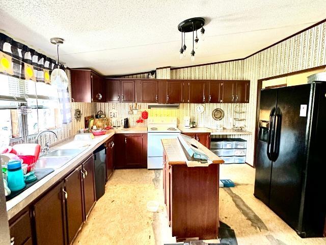  - kitchen featuring black fridge, white electric range oven, light countertops, a sink, and under cabinet range hood