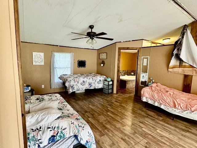  - bedroom featuring wood finished floors and a ceiling fan