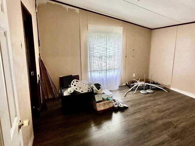  - spare room with wood finished floors and ornamental molding