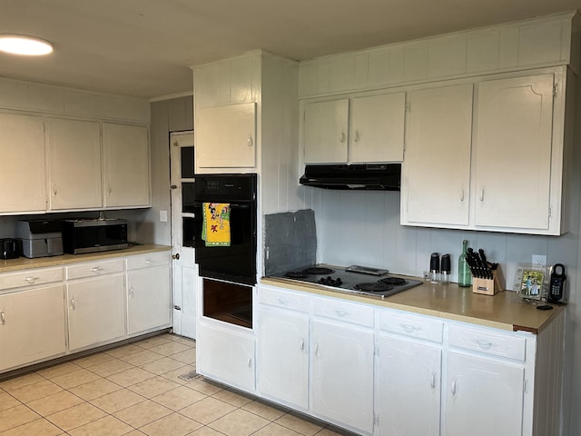 kitchen featuring black oven, stovetop, white cabinets, and light tile patterned floors