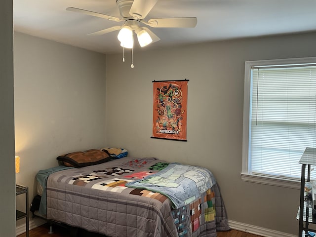 bedroom with ceiling fan and hardwood / wood-style flooring