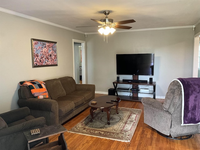 living room with hardwood / wood-style floors, ceiling fan, and crown molding