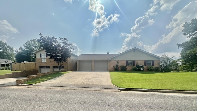  - view of front facade with concrete driveway, brick siding, a garage, and a front yard