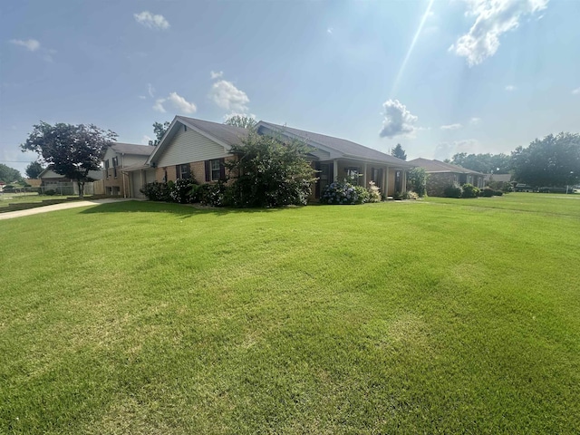 - view of home's exterior featuring a lawn and brick siding