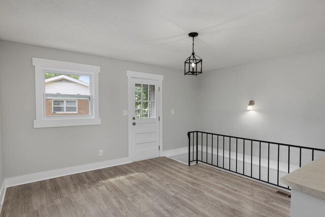  - entryway with light wood finished floors and healthy amount of natural light