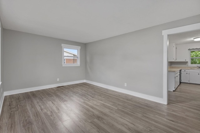  - unfurnished room with light wood finished floors and baseboards
