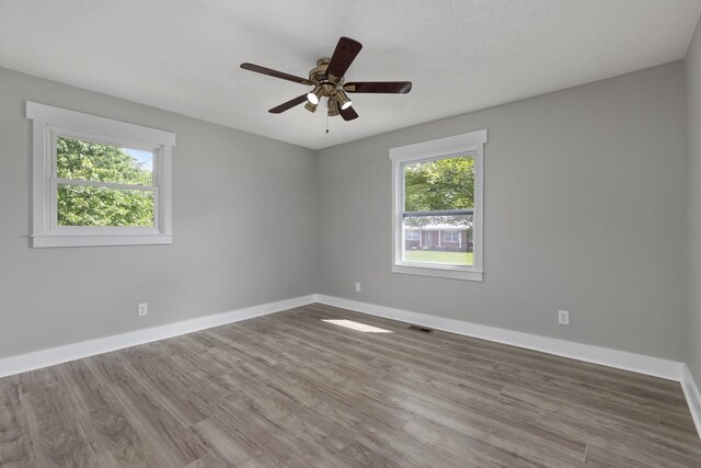  - unfurnished room featuring wood finished floors and ceiling fan