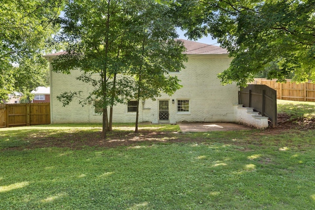  - back of house featuring brick siding and a patio