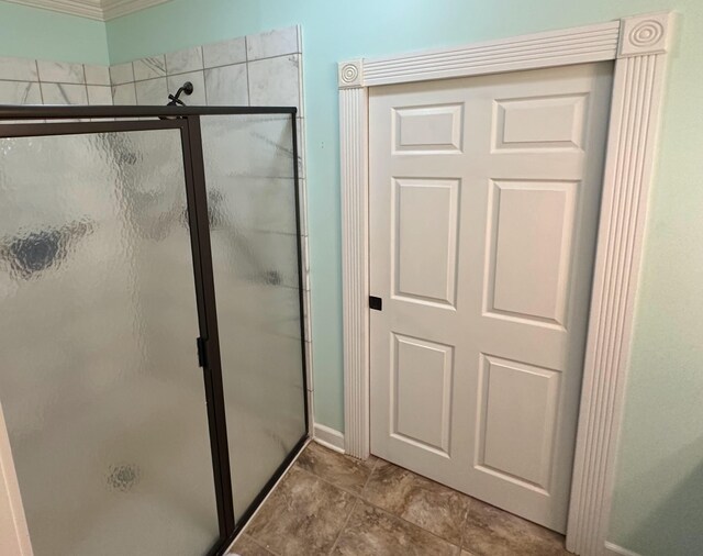 bathroom featuring a shower with door