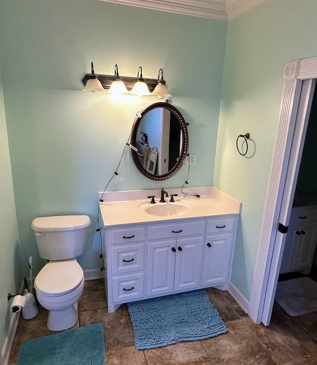 bathroom with crown molding, vanity, and toilet