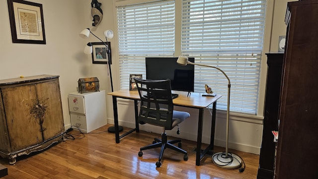 office area featuring baseboards and wood finished floors