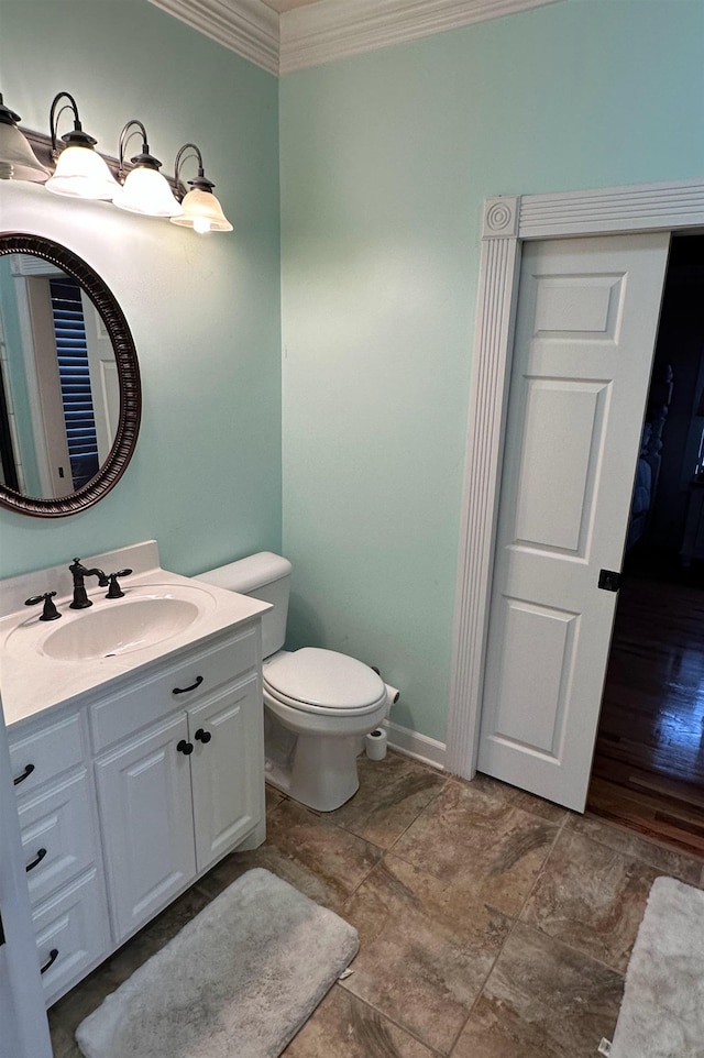 bathroom featuring ornamental molding, vanity, and toilet