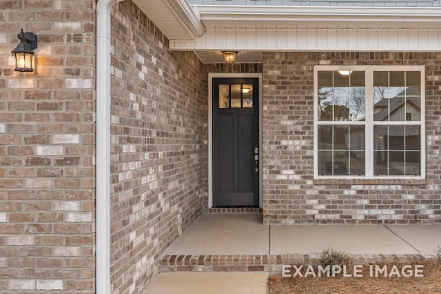 view of exterior entry with brick siding