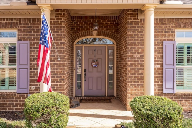 doorway to property with brick siding