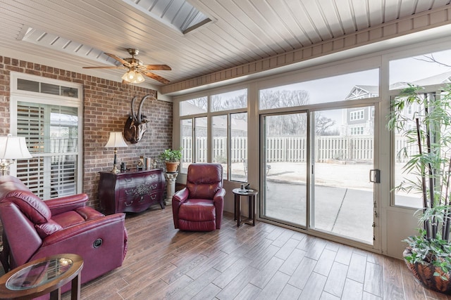 sunroom featuring a wealth of natural light, wood ceiling, and ceiling fan