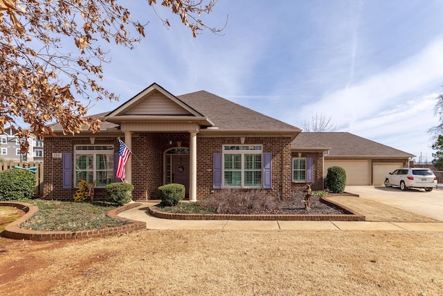 ranch-style house with a garage, concrete driveway, brick siding, and a shingled roof