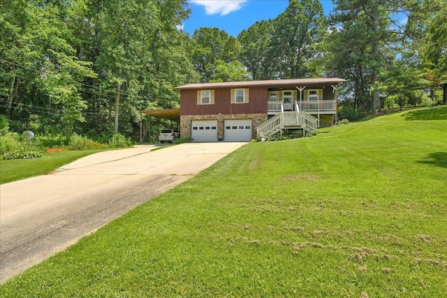  - view of front facade featuring stairs, concrete driveway, a porch, an attached garage, and a front yard