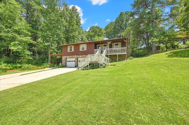 - view of front facade with a porch, stairs, a front yard, and driveway