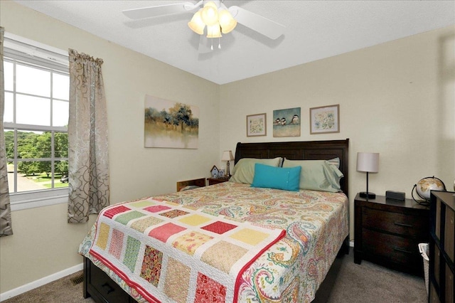 - carpeted bedroom featuring multiple windows and ceiling fan
