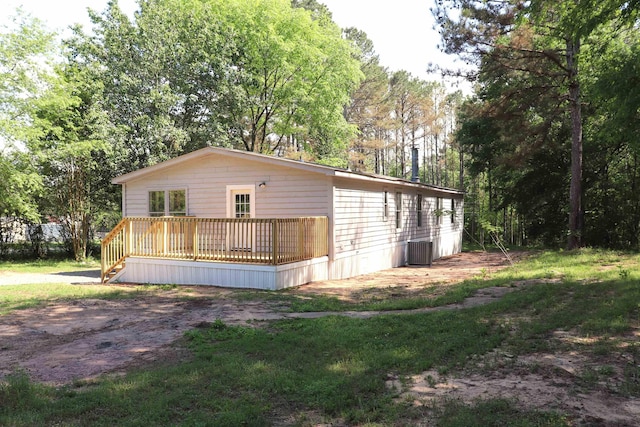  - exterior space with cooling unit and a wooden deck