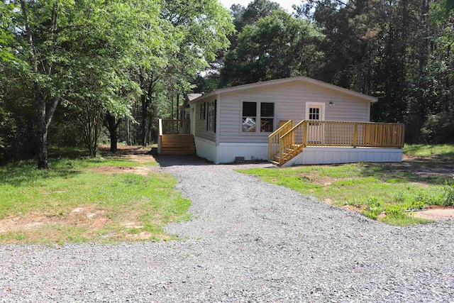  - manufactured / mobile home with a deck and gravel driveway
