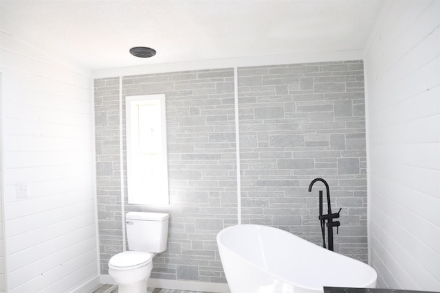  - full bathroom with a freestanding bath and toilet