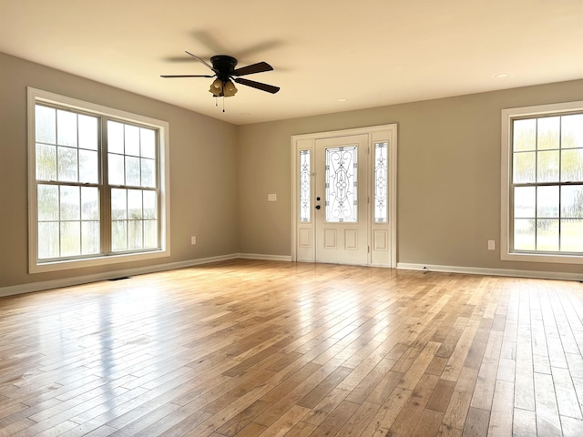 interior space featuring plenty of natural light, ceiling fan, and light wood-type flooring